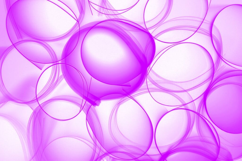 Vibrant abstract design with intertwined purple circles on a light background.